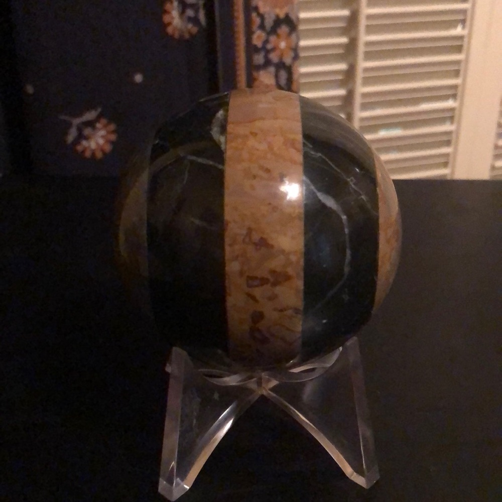 Striped stone sphere in earthy browns and blacks
